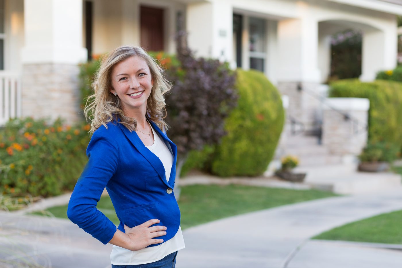 Paige Kearl, REALTOR®, standing in front of an East Valley home